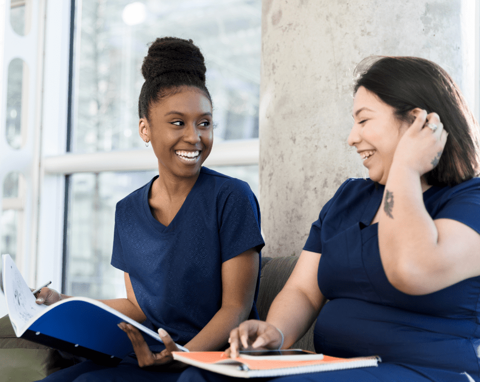 Two nursing students studying and laughing